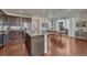 A spacious kitchen featuring granite countertops, dark wood cabinets, stainless steel appliances, and a large island at 17548 Bluetrail Ave, Parker, CO 80134