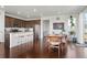 Open concept kitchen with stainless steel appliances, dark cabinetry, granite countertops and an island with bar seating at 17548 Bluetrail Ave, Parker, CO 80134