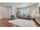 Bright living room features large windows, comfortable seating, and neutral decor, creating an inviting atmosphere at 17548 Bluetrail Ave, Parker, CO 80134