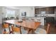 Open-concept living and dining area with hardwood floors and stainless steel appliances at 17548 Bluetrail Ave, Parker, CO 80134