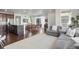 Open concept living space with hardwood floors, modern furnishings, and a seamless flow between kitchen and living areas at 17548 Bluetrail Ave, Parker, CO 80134
