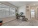Cozy home office with a desk, chair, natural light from the window, and a view of the hallway at 17548 Bluetrail Ave, Parker, CO 80134