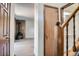 Open-concept living space with hardwood floors, stone fireplace, and staircase access to upper floors at 1211 W 112Th Ave # B, Denver, CO 80234