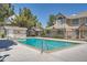 Outdoor pool surrounded by fencing, foliage and nearby houses at 1211 W 112Th Ave # B, Denver, CO 80234