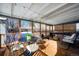 Covered patio with wooden deck, table, chairs, and comfy seating at 5123 Bryant St, Denver, CO 80221