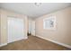 Simple bedroom with double door closet and window at 5123 Bryant St, Denver, CO 80221