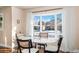 Bright dining area with bay window and seating for four at 5123 Bryant St, Denver, CO 80221