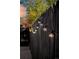 Black wooden fence with string lights adding ambiance at 5123 Bryant St, Denver, CO 80221