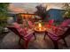 Cozy fire pit area with red chairs, perfect for outdoor gatherings at 5123 Bryant St, Denver, CO 80221