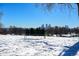 Snowy landscape with bench offering scenic city view at 5123 Bryant St, Denver, CO 80221