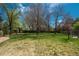 Expansive backyard with lush lawn, mature trees and a wooden fence at 5361 Nassau Cir, Cherry Hills Village, CO 80113