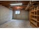 Unfinished basement featuring exposed wood beams and a small window at 5361 Nassau Cir, Cherry Hills Village, CO 80113