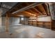 Spacious unfinished basement with shelving and exposed ceiling at 5361 Nassau Cir, Cherry Hills Village, CO 80113
