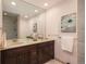 Bathroom featuring a double vanity, framed mirrors, and elegant tilework at 5361 Nassau Cir, Cherry Hills Village, CO 80113