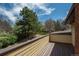 Wooden deck with view of backyard landscaping and mature trees at 5361 Nassau Cir, Cherry Hills Village, CO 80113