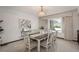 Elegant dining room featuring a large window, modern lighting, and a stylish table set for six at 5361 Nassau Cir, Cherry Hills Village, CO 80113