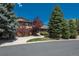 Charming two-story home with landscaped yard and inviting curb appeal, surrounded by mature trees and a well-maintained lawn at 5361 Nassau Cir, Cherry Hills Village, CO 80113