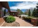 Brick walkway in front yard framed by verdant bushes and brick columns, leads to the house, enhancing curb appeal at 5361 Nassau Cir, Cherry Hills Village, CO 80113