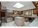 Bright kitchen with a skylight, island, and stainless steel refrigerator at 5361 Nassau Cir, Cherry Hills Village, CO 80113