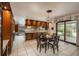 Spacious kitchen with wood cabinets, tile flooring, and sliding glass doors leading to the backyard at 5361 Nassau Cir, Cherry Hills Village, CO 80113