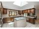 Kitchen with wooden cabinetry, an island, and a stainless steel refrigerator at 5361 Nassau Cir, Cherry Hills Village, CO 80113