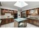 Kitchen featuring wooden cabinets, a gas range, and a large island at 5361 Nassau Cir, Cherry Hills Village, CO 80113