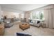 Spacious living room leading to the dining area, featuring large windows and neutral tones for a bright and airy feel at 5361 Nassau Cir, Cherry Hills Village, CO 80113