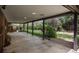 Relaxing covered patio with concrete floors, supports and views of the landscaped backyard at 5361 Nassau Cir, Cherry Hills Village, CO 80113