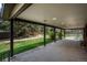 Expansive covered patio perfect for outdoor living, with views of the lush green backyard and mature trees at 5361 Nassau Cir, Cherry Hills Village, CO 80113
