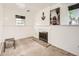 Finished basement area with carpet, a decorative fireplace, and natural light from a window at 1956 Cathay St, Aurora, CO 80011