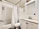 Clean bathroom features a vanity sink with granite top, neutral fixtures, and a shower-tub combo at 1956 Cathay St, Aurora, CO 80011