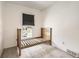 Cozy bedroom with neutral carpet and single bed frame near window for a light-filled space at 1956 Cathay St, Aurora, CO 80011