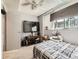 Bedroom featuring a window with blinds, ceiling fan and light fixture, and a TV on a stand at 1956 Cathay St, Aurora, CO 80011