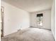 Bright, carpeted bedroom with a window, closet, and neutral walls, creating a serene and comfortable living space at 1956 Cathay St, Aurora, CO 80011