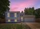 Charming home with a garage and landscaped front yard set against a beautiful twilight sky, offering suburban living at 1956 Cathay St, Aurora, CO 80011