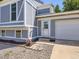 Close-up of a home's entrance, featuring a glass front door, textured walls, and well-manicured landscaping at 1956 Cathay St, Aurora, CO 80011