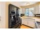 Kitchen area featuring white cabinets, stainless steel appliances, and modern countertops at 1956 Cathay St, Aurora, CO 80011