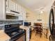 Functional kitchen featuring black appliances, mosaic backsplash, and adjacent dining area, perfect for easy meal prep at 1956 Cathay St, Aurora, CO 80011