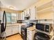 Well-lit kitchen showcasing white cabinets, stainless steel appliances, and a wood countertop at 1956 Cathay St, Aurora, CO 80011