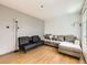 Inviting living room features laminate flooring, and comfortable seating with a large sectional at 1956 Cathay St, Aurora, CO 80011