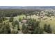 Wide aerial view of a home and expansive lot surrounded by mature trees and lush landscape at 7641 Kelty Trl, Franktown, CO 80116