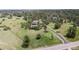 An aerial view of a two-story home on a green lot surrounded by mature trees at 7641 Kelty Trl, Franktown, CO 80116