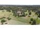 Aerial view of home with mature landscaping and a long driveway, surrounded by trees at 7641 Kelty Trl, Franktown, CO 80116