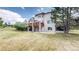 Exterior rear of home shows a multi-story house and a spacious green backyard at 7641 Kelty Trl, Franktown, CO 80116
