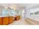 Bright bathroom featuring a dual sink vanity and a soaking tub at 7641 Kelty Trl, Franktown, CO 80116