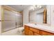 Bathroom features a shower-tub combo, a sink, and a vanity at 7641 Kelty Trl, Franktown, CO 80116