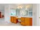 Bathroom with a dual sink vanity and large mirrors at 7641 Kelty Trl, Franktown, CO 80116