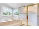 Bright bathroom featuring a tub and a shower at 7641 Kelty Trl, Franktown, CO 80116