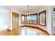 Dining area featuring hardwood floors, natural light, and wood trim windows at 7641 Kelty Trl, Franktown, CO 80116
