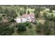 A back view of the house, including a wooden deck, surrounded by mature trees at 7641 Kelty Trl, Franktown, CO 80116